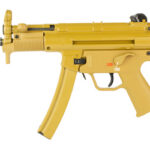 Yellow compact automatic firearm with a curved magazine and pistol grip, viewed profile.