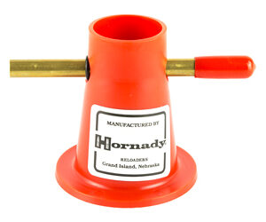 Orange Hornady reloading tool with two brass rods extending left and right; label reads 'Manufactured by Hornady'.