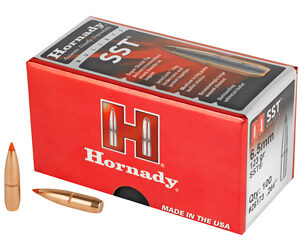 Red Hornady SST ammunition box with two copper hollow-point bullets beside it.
