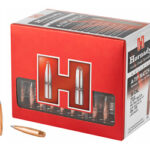 Red Hornady ammo box with two bullets beside it on a white background.