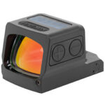 Compact red dot sight for firearms, with orange-tinted lens, two side adjustment buttons, and a mounting base.