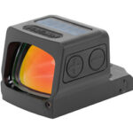 Compact red-dot reflex sight with orange-tinted lens and side adjustment dials on a mounting base