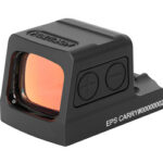 Compact red dot sight optic with orange lens mounted on a black rail base for firearms targeting
