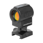 Black compact red-dot reflex sight mounted on a rail for aiming on a firearm.