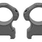 Pair of gray rifle scope rings with circular hoops and screw holes for mounting a scope on a rifle.”, “Two scope rings for mounting a rifle scope, shown side by side from the front.”, “Double set of gray clamp-on scope mounts with circular rings and bottom supports.