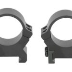 Pair of black rifle scope rings on a white background, used to secure a scope to a rifle rail.