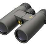 Gray binoculars with black eyepieces and a central hinge, shown at an angled front-right viewpoint.