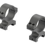 Pair of gray metal rifle scope rings with base mounts, viewed at an angle.