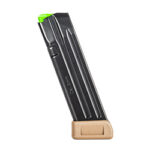 Black handgun magazine with a green follower perched in a small wooden display stand.