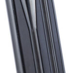 Close-up of a black staple gun magazine with metal rails and a rounded base.