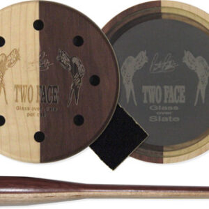 Two round wooden discs with holes and a slate insert labeled Two Face, plus a matching wooden tamper, part of a glass-over-slate smoking set.