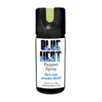 Pepper spray can labeled 'BLUE HEAT Pepper Spray' with a black cap and green safety tab, used for personal defense.