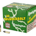 Remington .22 Thunderbolt ammunition box with two bullets beside it on a white background.