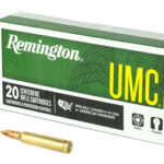 Remington UMC box of 20 centerfire rifle cartridges with two copper bullets placed beside it.