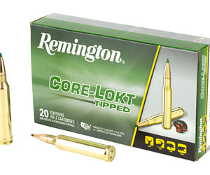 Remington Core-Lokt tipped rifle ammunition box with two loose cartridges beside it.