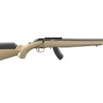 Tan hunting rifle with a black barrel, scope rail on top, and a curved magazine, lying horizontally.
