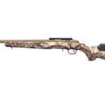Camouflage-pattern hunting rifle with a long barrel, beige-brown stock, and top Picatinny rail.