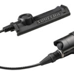 SureFire remote pressure switch with a coiled cord attached to a tactical flashlight head.