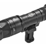 Compact black tactical flashlight with a mounting clip for rail systems and knurled grip.