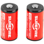 Two red SureFire lithium primary batteries standing upright side by side.