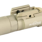 Beige SureFire tactical flashlight with a mounting rail, designed to attach to a firearm (compact weapon light).
