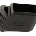 Black plastic firearm accessory with a large rectangular slot and ribbed grip, viewed from above.