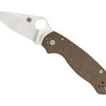 Folding pocket knife with a brown textured handle and a silver blade featuring a circular thumb hole.