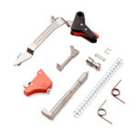 Assorted metal repair tools and components laid out on a white background.