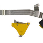 Long grooved silver lever with a yellow wedge and a black-yellow pivot block, part of mechanical hardware components.