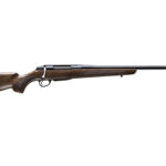 Profile view of a long-barreled shotgun with a wooden stock and metal barrel.