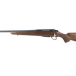 Bolt-action rifle with wooden stock and long blued barrel, shown in profile from the left.