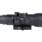 Black riflescope with large front lens, adjustment turrets, and a mounting base seen from the side