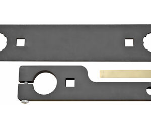 Two metal mounting pieces: a long curved plate with two large circular holes and two square openings, and a smaller clamp with a brass contact strip nearby.
