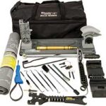 Complete tool kit laid out in front of a black carrying bag, including pliers, wrenches, tape, blades, and assorted repair tools.