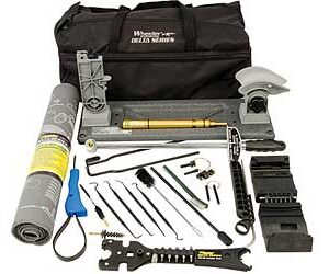 Complete tool kit laid out in front of a black carrying bag, including pliers, wrenches, tape, blades, and assorted repair tools.