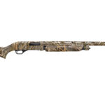 Camouflage-pattern hunting shotgun shown in profile with long barrel and wooden stock