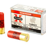 Box of Winchester Super-X Turkey shotgun shells (12 gauge) with two red brass shells beside it.