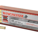 Winchester .22 Long Rifle ammunition box with 40 hollow-point rounds; three rounds lie beside it.