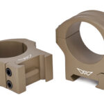 Pair of tan rifle scope mounting rings with four-screw clamps for attaching a scope