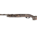 Camouflaged hunting shotgun lying horizontally with a long barrel and stock against a white background on a side profile.