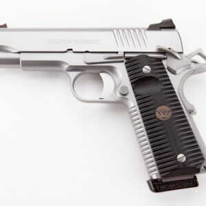 Close-up of a silver Wilson Combat semi-automatic pistol with a black textured grip.