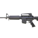 Profile view of a black modern assault rifle with a ribbed fore-end and adjustable stock.