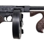 Decorative firearm: long-barreled submachine gun with carved wooden stock and grip, and a drum magazine attached.