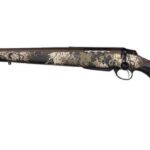 Bolt-action hunting rifle with a camouflage-pattern stock and long barrel, shown from side. It’s a scoped-looking rifle with a black butt pad and curved trigger guard.
