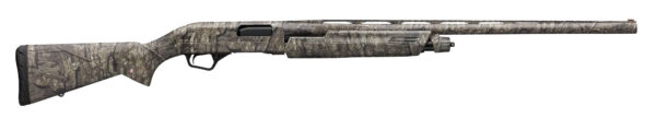 Camouflage-pattern hunting shotgun with a long barrel seen from the side and a black recoil pad at the stock end.