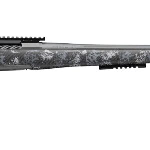 Camouflaged bolt‑action rifle with a long barrel and muzzle brake on a white background, showing a Picatinny rail and no scope attached.